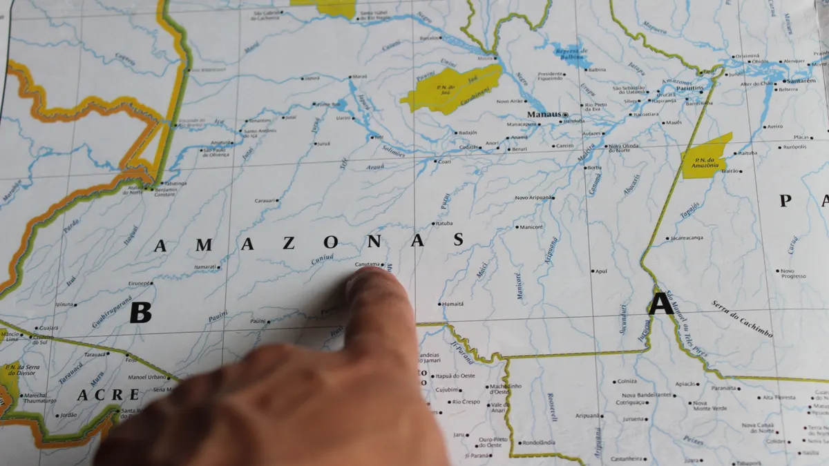 hand pointing to a paper map