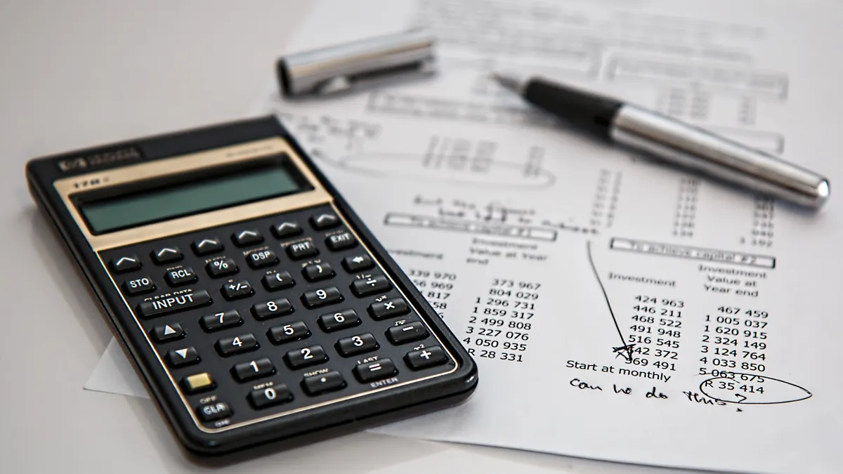 calculator on tax forms with pen