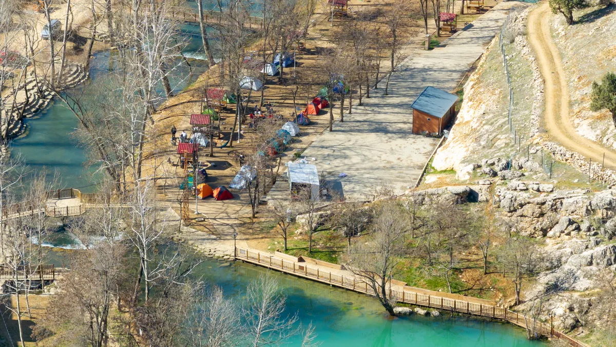 riverside campground with tents and cabins