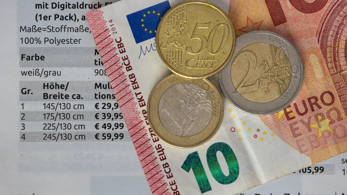 Euro coins and notes on a price list