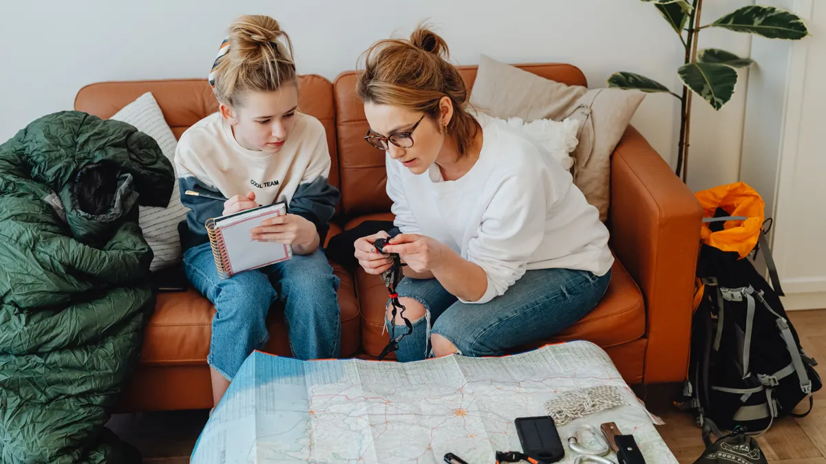 Family planning a trip with map and travel gear
