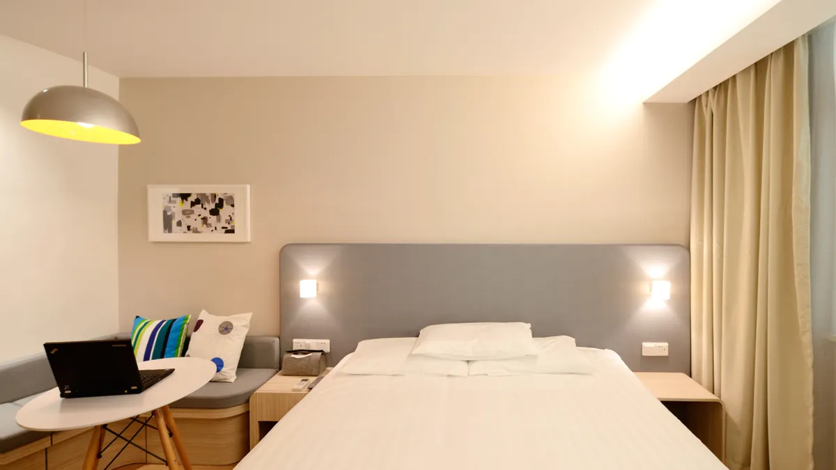 Hotel bedroom with large bed and side table